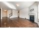 Spacious living room featuring a fireplace, staircase, and hardwood floors throughout at 1929 Shorthorn St, Charlotte, NC 28213