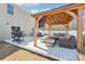 Outdoor deck with covered pergola, perfect for entertaining with grill and comfortable seating area at 2027 Redstone Dr, York, SC 29745