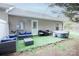 Back patio with hot tub, outdoor seating, and artificial turf at 222 Baldwin Ct, Rock Hill, SC 29730