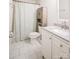 Clean, bright bathroom with a white vanity, tile floor, and shower with a decorative curtain at 222 Baldwin Ct, Rock Hill, SC 29730
