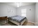 Cozy bedroom featuring a ceiling fan, natural light, and a comfortable bed with stylish patterned bedding at 222 Baldwin Ct, Rock Hill, SC 29730