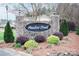 Landscaped entrance to Meadow Creek neighborhood shows stone sign, colorful plantings at 222 Baldwin Ct, Rock Hill, SC 29730