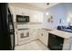 Bright kitchen with black appliances, stainless sink, and white cabinets at 222 Baldwin Ct, Rock Hill, SC 29730