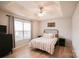 Cozy main bedroom with a tray ceiling, a ceiling fan, and hardwood floors at 222 Baldwin Ct, Rock Hill, SC 29730