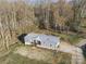 Aerial shot of the gray home, featuring a metal roof and a wooded surrounding at 2390 Old Wilkesboro Rd, Statesville, NC 28625