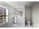 Bathroom with double sink vanity, mirror, marble floors, and toilet at 2390 Old Wilkesboro Rd, Statesville, NC 28625