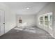 Bedroom with carpet and view to the back deck through two windows at 2390 Old Wilkesboro Rd, Statesville, NC 28625