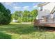Spacious backyard with lush lawn, privacy fence, and wooden deck at 2514 Waters Vista Cir, Charlotte, NC 28213