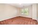Neutral bedroom featuring natural light, carpet flooring, and ample space at 2514 Waters Vista Cir, Charlotte, NC 28213