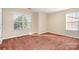 Carpeted bedroom featuring natural light, neutral walls, and modern trim at 2514 Waters Vista Cir, Charlotte, NC 28213