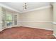 A formal dining room with bright windows and an elegant chandelier is the perfect setting at 2514 Waters Vista Cir, Charlotte, NC 28213