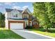 Beautiful two story home with brick and vinyl siding, attached two car garage, and well manicured lawn at 2514 Waters Vista Cir, Charlotte, NC 28213