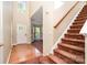 Bright foyer with hardwood floors, staircase with carpet, and view into the large sunny living room at 2514 Waters Vista Cir, Charlotte, NC 28213