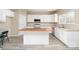 Spacious kitchen features white cabinets, butcher block island, stainless appliances, and tile floors at 2514 Waters Vista Cir, Charlotte, NC 28213