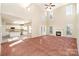 Spacious living room with tall ceilings, fireplace, and view into the bright eat-in kitchen at 2514 Waters Vista Cir, Charlotte, NC 28213