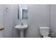 Powder room with pedestal sink, mirror, and toilet at 3308 Lemongrass Ln, Charlotte, NC 28214