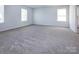 Spacious bedroom with neutral carpet and two windows at 3308 Lemongrass Ln, Charlotte, NC 28214