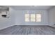 Bright living room featuring modern gray wood flooring, neutral walls and natural lighting at 3308 Lemongrass Ln, Charlotte, NC 28214