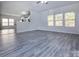 Spacious living room with modern gray wood flooring, bright lighting and an open floor plan at 3308 Lemongrass Ln, Charlotte, NC 28214
