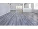 Spacious living room with modern gray wood flooring, bright lighting and an open floor plan at 3308 Lemongrass Ln, Charlotte, NC 28214
