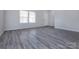 Bright living room featuring modern gray wood flooring, neutral walls and natural lighting at 3308 Lemongrass Ln, Charlotte, NC 28214