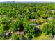 An aerial view showing a home in a verdant neighborhood with tree-lined streets at 3330 Foxcroft Rd, Charlotte, NC 28211