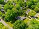 An aerial view of a home in an established neighborhood with mature tree coverage at 3330 Foxcroft Rd, Charlotte, NC 28211