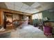 Unfinished basement area featuring a vintage brick bar and room for entertaining at 3330 Foxcroft Rd, Charlotte, NC 28211