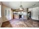 Cozy dining area featuring wood paneling, parquet flooring, and a decorative light fixture at 3330 Foxcroft Rd, Charlotte, NC 28211