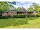 Classic brick home featuring a well-maintained lawn and trimmed hedges in a peaceful, suburban setting at 3330 Foxcroft Rd, Charlotte, NC 28211