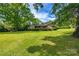 Charming single-story brick home with a lush green lawn and mature trees at 3330 Foxcroft Rd, Charlotte, NC 28211