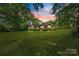 Charming brick home with a lush green lawn and mature trees, perfect for enjoying the outdoors at 3330 Foxcroft Rd, Charlotte, NC 28211