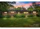 Charming brick home with well-maintained landscaping and a spacious front lawn at 3330 Foxcroft Rd, Charlotte, NC 28211
