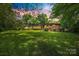 A lovely brick home surrounded by mature trees and a large, well-manicured lawn at 3330 Foxcroft Rd, Charlotte, NC 28211