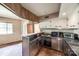 Compact kitchen featuring stainless steel counters, vintage white cabinets, and updated appliances at 3330 Foxcroft Rd, Charlotte, NC 28211