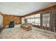 Sunlit living room with large windows and access to enclosed porch at 3330 Foxcroft Rd, Charlotte, NC 28211
