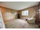 Spacious room with wood paneling and neutral carpet, perfect for an office or workout area at 3330 Foxcroft Rd, Charlotte, NC 28211