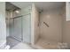 Bathroom shower with tiled walls and built-in storage at 3330 Foxcroft Rd, Charlotte, NC 28211