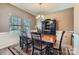 Formal dining room showcases a wooden table, elegant hutch, and natural light from the window at 4026 Clover Nw Rd, Concord, NC 28027