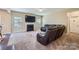 Comfortable living room featuring plush seating, a cozy fireplace, and a large wall-mounted television at 4026 Clover Nw Rd, Concord, NC 28027