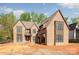 Craftsman-style home with multi-paned windows and brick exterior awaiting landscaping at 412 Jefferson Dr, Charlotte, NC 28270