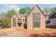 Craftsman-style home with multi-paned windows and brick exterior awaiting landscaping at 412 Jefferson Dr, Charlotte, NC 28270