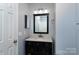 Updated bathroom with a stylish vanity, framed mirror, and well-lit shower area at 4548 Antelope Ln, Charlotte, NC 28269