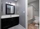 Updated bathroom with a modern vanity, framed mirror, and convenient toilet at 4548 Antelope Ln, Charlotte, NC 28269