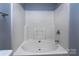 Clean, white bathtub enclosure offers a serene space for relaxation with a refreshing shower at 4548 Antelope Ln, Charlotte, NC 28269