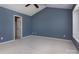 A roomy bedroom boasts vaulted ceilings, soft carpeting, and a refreshing ceiling fan at 4548 Antelope Ln, Charlotte, NC 28269