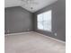 Well-lit bedroom with a cozy ceiling fan, soft carpet, and a sunny window at 4548 Antelope Ln, Charlotte, NC 28269