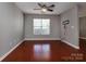 Spacious bedroom with hardwood floors, a ceiling fan, and a large window at 4548 Antelope Ln, Charlotte, NC 28269