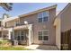 Back exterior view of townhome with light gray siding, windows, and an air conditioning unit at 4548 Antelope Ln, Charlotte, NC 28269