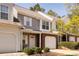 A townhouse featuring a brick facade, attached garage, and well-maintained landscaping at 4548 Antelope Ln, Charlotte, NC 28269